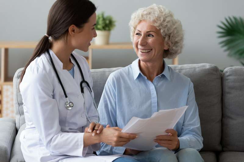 Young doctor meets with older female patient