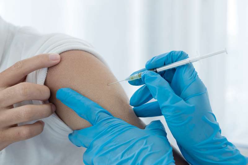 Close-up image of patient's arm receiving injection