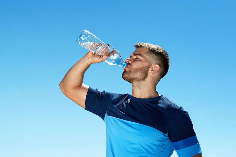 Young male drinking water