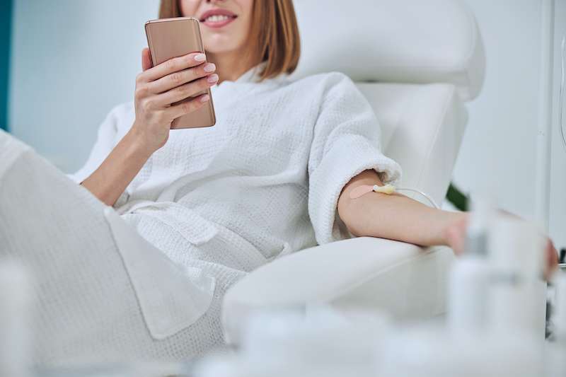 young woman receiving IV treatment