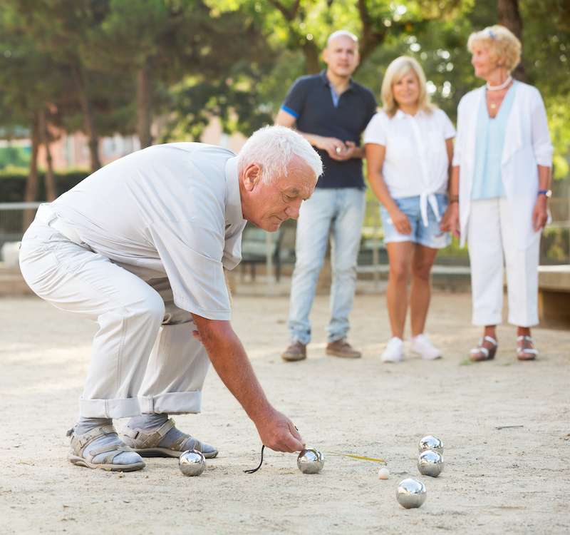 older male playing bocce