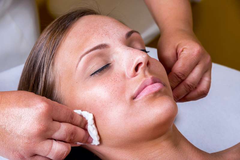 Young woman receiving chemical peel procedure