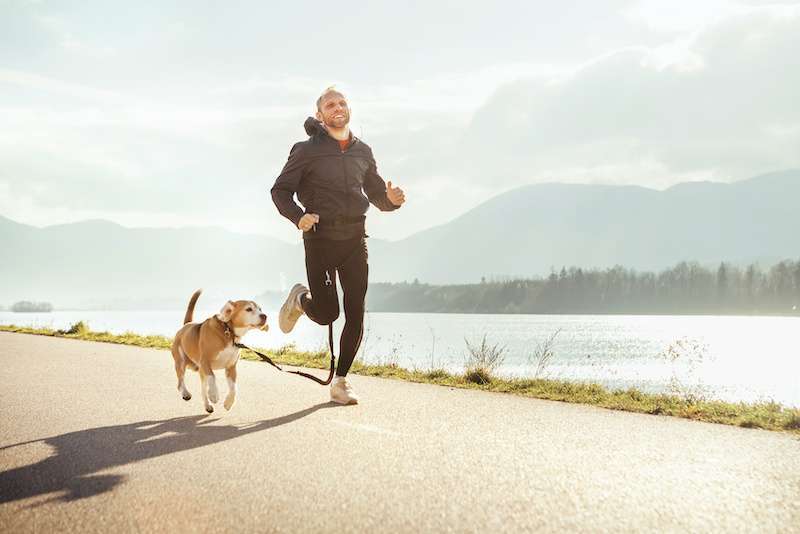 young man on a run with his dog