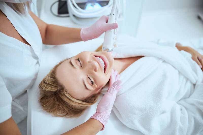 Microneedling Young girl receiving microneedling treatment