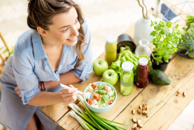 young woman eating a salad