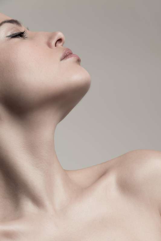 Close-up image of young woman's neck and face