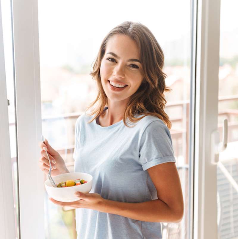 young woman eating a healthy salad