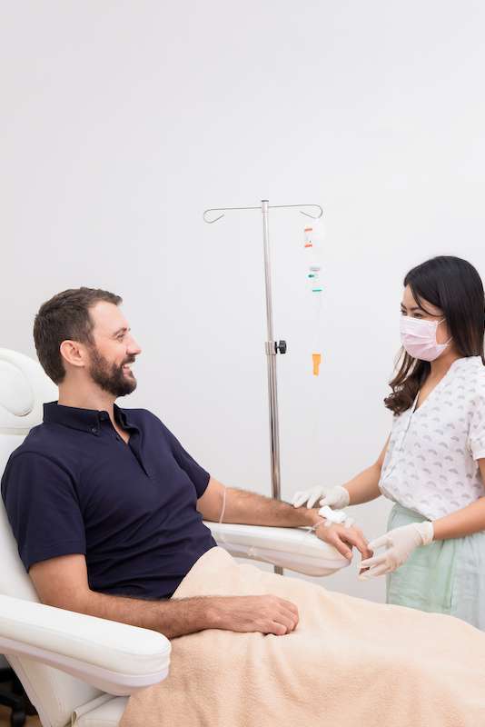 young male receiving iv therapy treatment