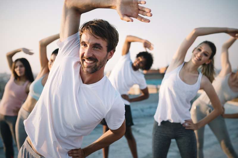 group of young people practicing yoga