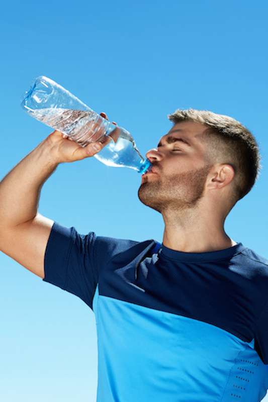 Young male drinking water