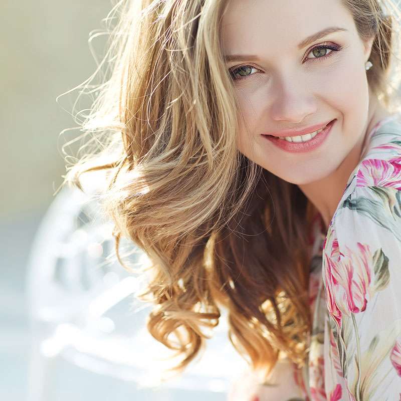 woman in flowery dress smiling