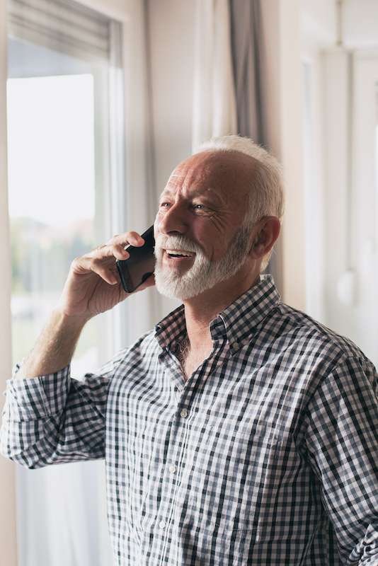 older man talking on the phone