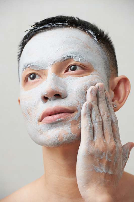 young man applying face mask