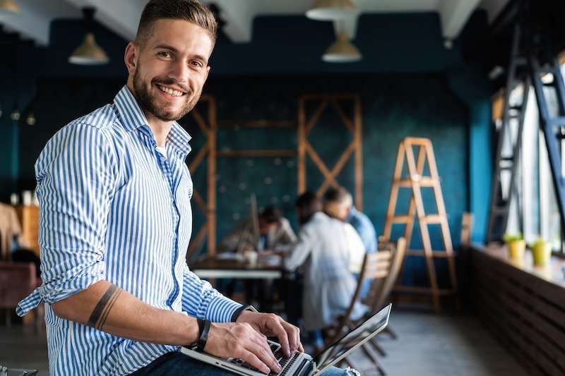 happy young man working on a computer