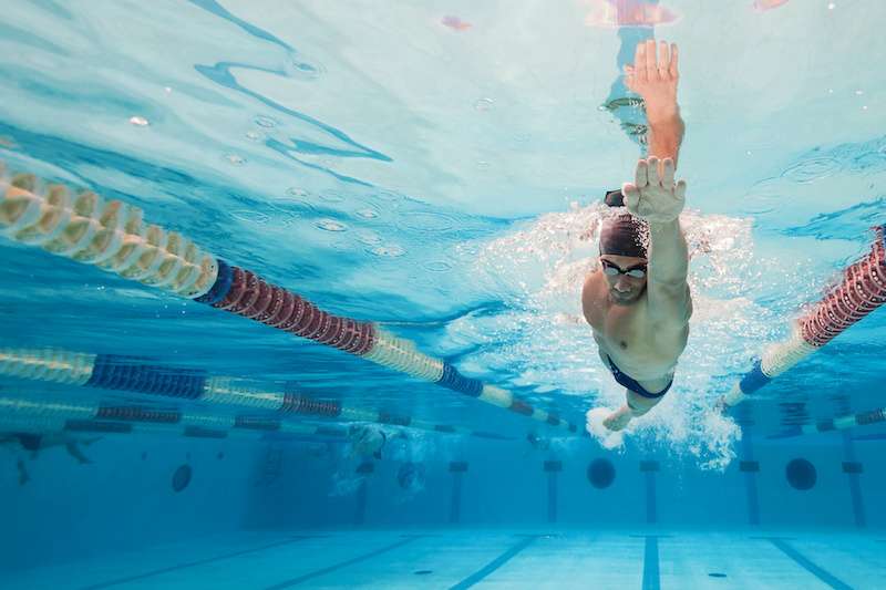 man swimming in a pool