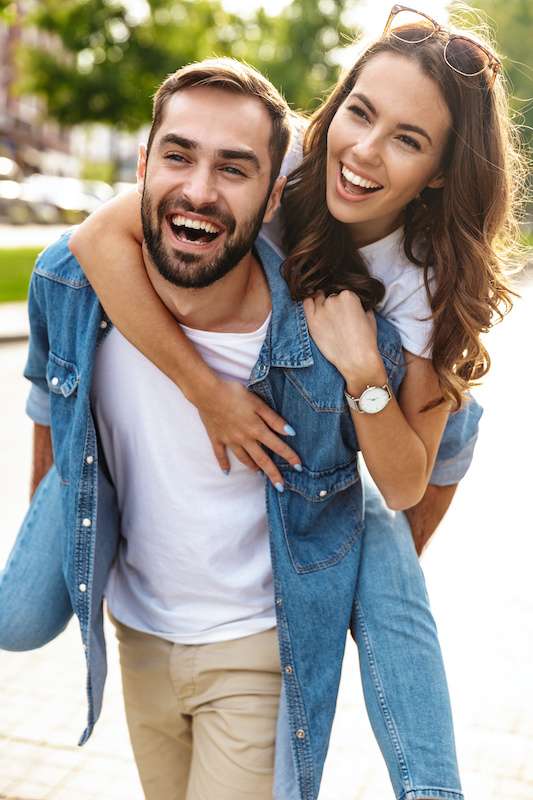 young couple enjoying a piggy back ride