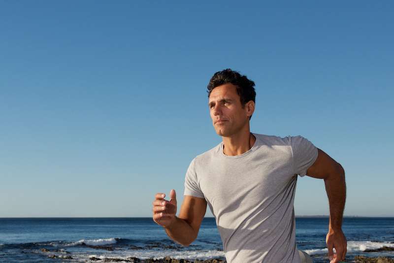 man running outdoors by the beach