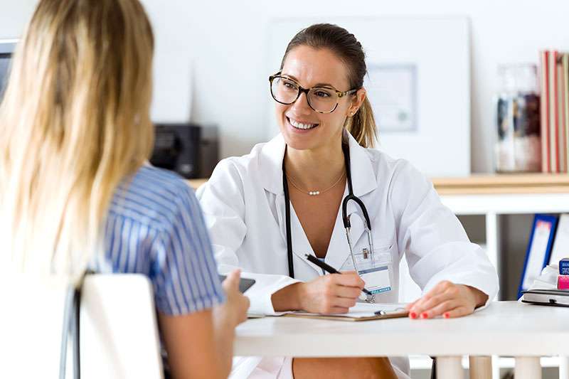 Female doctor explaining diagnosis to her patient.