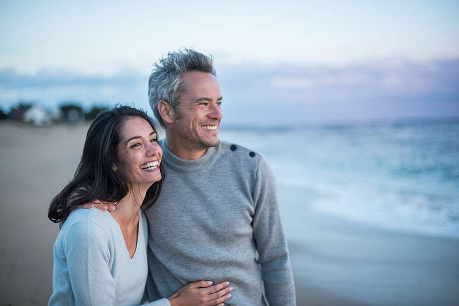 Portrait of a couple walking on the beach