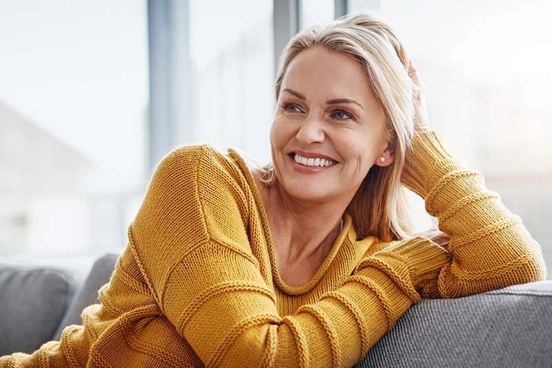 Woman wearing yellow shirt on the couch