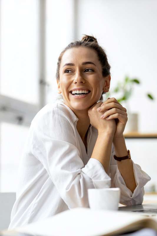 woman in flowery dress smiling