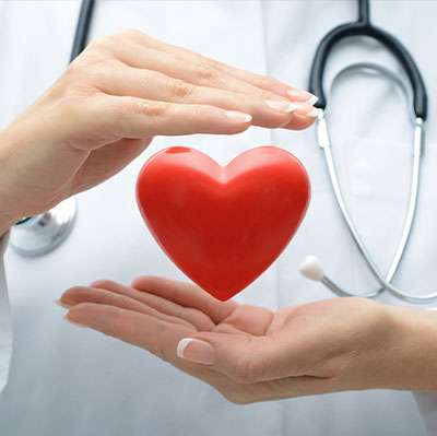 doctors hands holding heart symbol red alert screening at forward healthy lifestyles