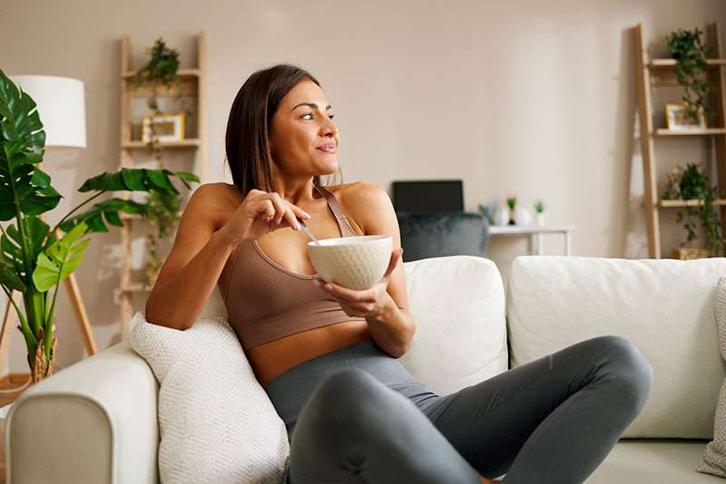 woman eating from bowl