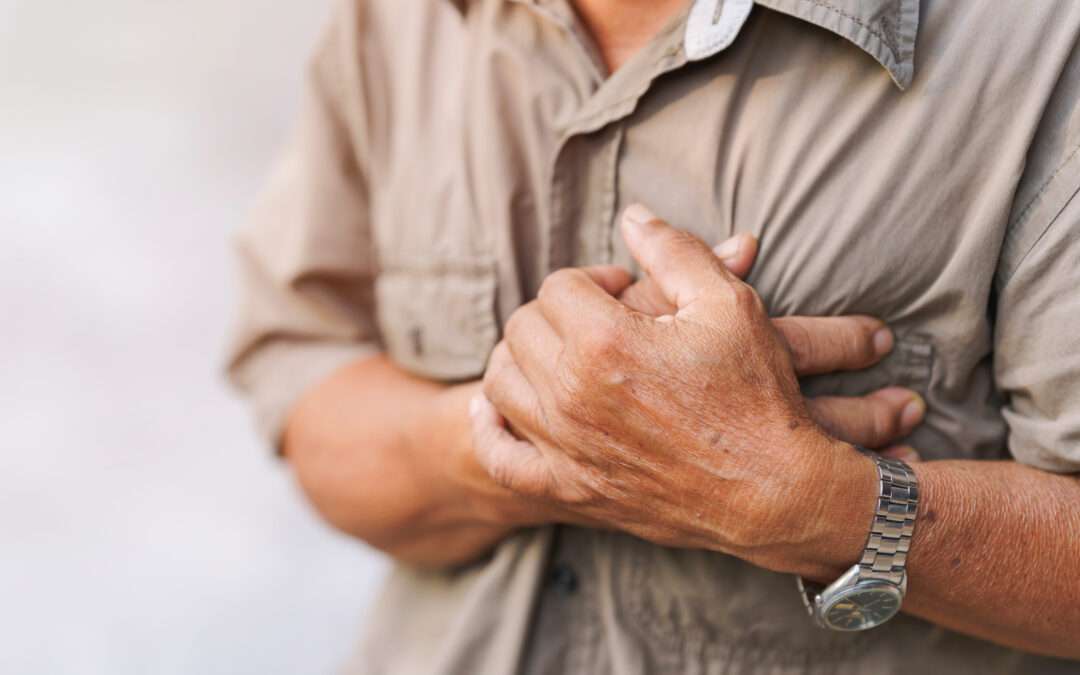 Man experiencing chest pain, a possible symptom of a heart attack.