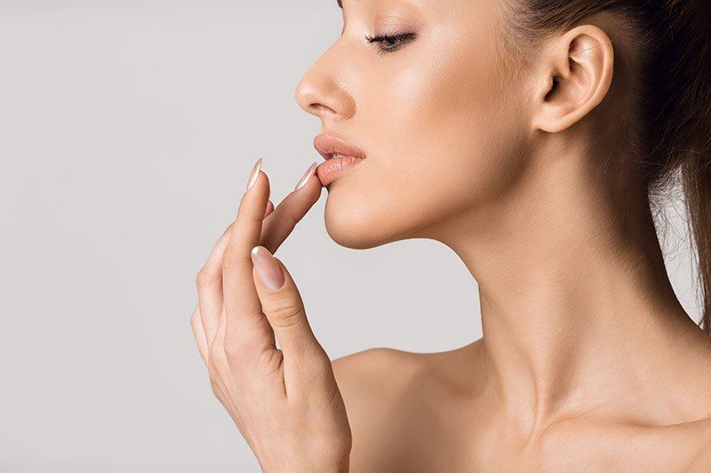 Beautiful girl touching her lips