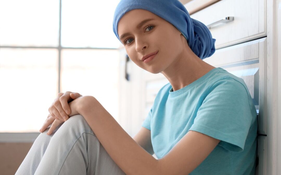 Teenage girl after chemotherapy sitting in kitchen